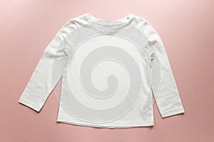 Blank white toddler girl`s long sleeved t-shirt on pink background