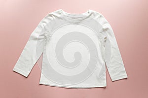 Blank white toddler girl`s long sleeved t-shirt on pink background photo
