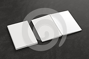 Blank white vertical closed and open and upside down book cover on black background isolated with clipping path around cover.