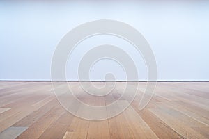 Blank white wall and hardwood floor in art gallery