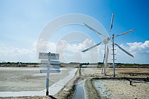Blank white wooden guidepost on salt lake with wind propelled. blank wooden sign painted using white color