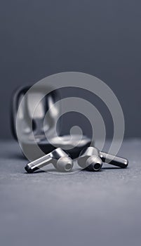 Blank wireless bluetooth earphones on black background