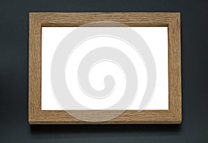 Blank wooden photo frame on black background