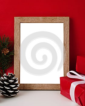 Blank wooden photo frame mockup template and christmas decoration on red blackground.