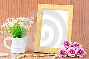 Blank wooden photo frame and pink rose