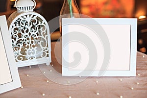 Blank wooden picture frame decoration on table decorated by whit