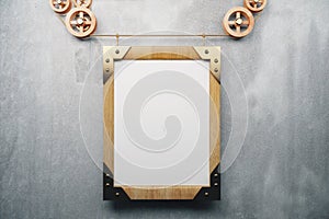 Blank wooden picture frame steampunk style on grey concrete wall