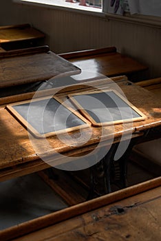 Blank Wooden Slates on Double School Desk Lit By Window Light