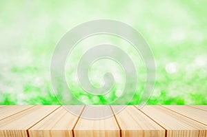 Blank wooden table with blur green grass background