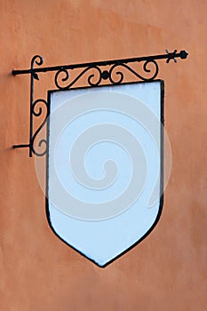 Blank wrought iron sign on wall photo
