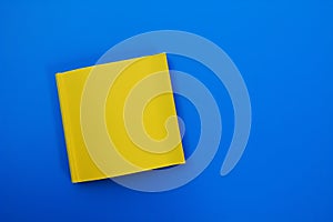 Blank yellow book on blue background. Top view with empty space