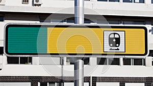 Blank yellow and green reflective road train station sign on the street