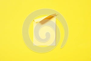 blank yellow note pad stick on vivid yellow background