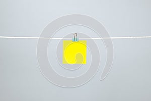 Blank yellow paper note on the string