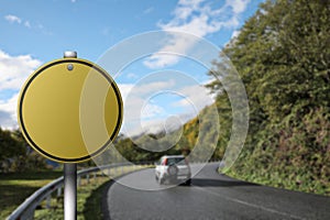 Blank yellow road sign on asphalt highway, space for text