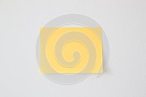 Blank Yellow Sticky Note on the White Wall