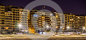 Blankenberge boulevard lighted at night, view on the beach and apartment buildings, touristic city in Belgium