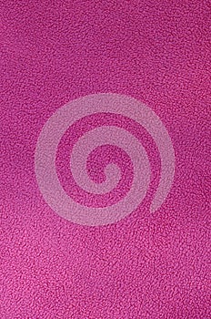 The blanket of furry pink fleece fabric. A background texture of light pink soft plush fleece materia