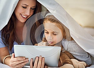 Blanket, tablet and mother with child on bed at home watch online video on app, internet or social media. Smile, love