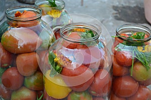 Blanks for the winter. Marinated. Red and yellow tomatoes in jars