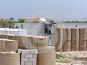 Blast barriers around a damaged trailer on a military camp in Iraq