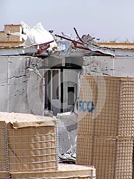 Blast barriers around a damaged trailer on a military camp in Iraq