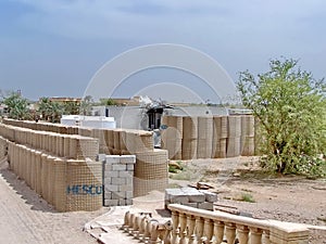 Blast barriers around a damaged trailer on a military camp in Iraq