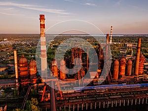 Blast furnace equipment of the metallurgical plant at the sunset, aerial view