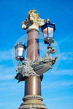 Blauwbrug Blue Bridge in Amsterdam. Columns decorated with lanterns.