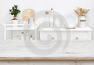 Bleached tabletop with copyspace over blurred kitchen furniture with tools