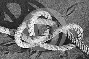 Knot of thick rope on sand