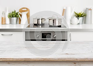 Bleached wooden texture table on defocused pastel color kitchen background