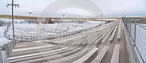 Bleachers overlooking a sports field covered with snow in winter