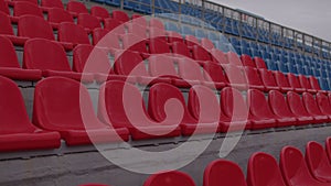 Bleachers in a sports stadium. Red and blue seats in a large street stadium.