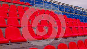 Bleachers in a sports stadium. Red and blue seats in a large street stadium.