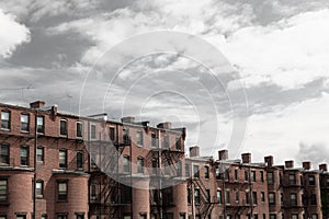 Bleak gray sky over old rowhouse, urban city dwellings