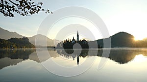 Bled island with pilgrimage church of the assumption of Mary on a foggy morning