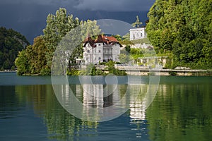 Bled lake and buildings in cloudy weather before rain and thunderstorms , Slovenia, Europe