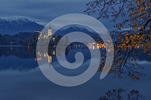 Bled lake and pilgrimage church at twilight reflected in water