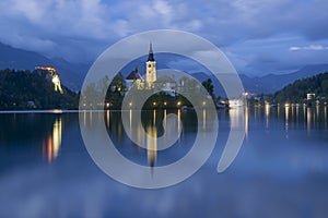 Bled lake and pilgrimage church at twilight reflected in water