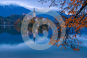 Bled lake and pilgrimage church at twilight reflected in water