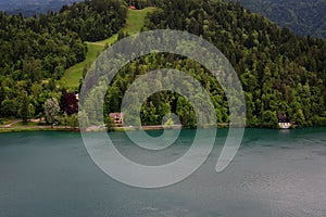 Bled Lake, shoreline mountain, alpine village in sunny weather, Slovenia, Europe.