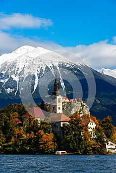 Bled lake with snow on the mountains in autumn