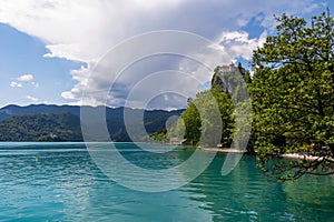 Bled - Panoramic view of St Mary Church of Assumption on the small island and castle at alpine lake