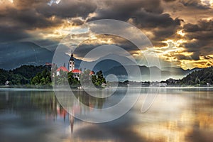 Bled, Slovenia - Amazing golden sunrise at Lake Bled Blejsko Jezero with the Pilgrimage Church of the Assumption of Maria