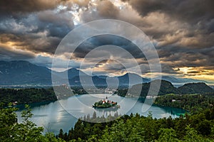 Bled, Slovenia - Dramatic sky and clouds above Lake Bled Blejsko Jezero with the Pilgrimage Church of the Assumption of Maria