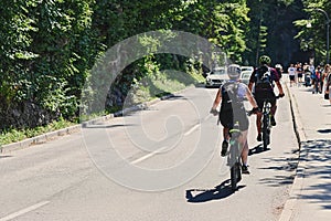 Bled, Slovenia - July 03, 2022: Couple road cycling uphill in Bled, Slovenia