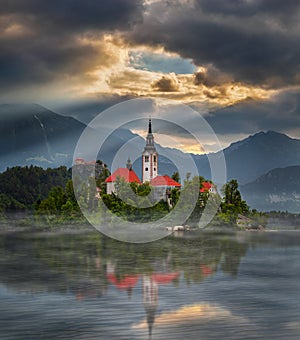 Bled, Slovenia - Misty sunrise at Lake Bled Blejsko Jezero with the Pilgrimage Church of the Assumption of Maria on an island photo