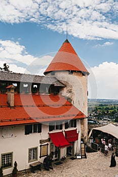 Bled, Slovenia - September, 8 2018: View of the The Bled Castle courtyard, tower and castle buildings with cafes and souvenir