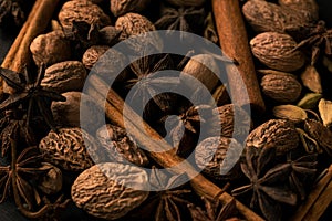 Blend of cinnamon, anise, nutmeg and cardamon spices dark photo closeup macro pattern